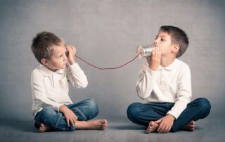 Effective Communication with the IEP Team Matters, image of two children communicating through tin cans.