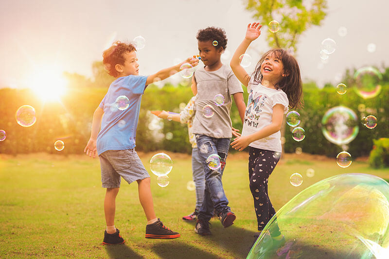 Brightside Law Group, image of kids playing with bubbles.